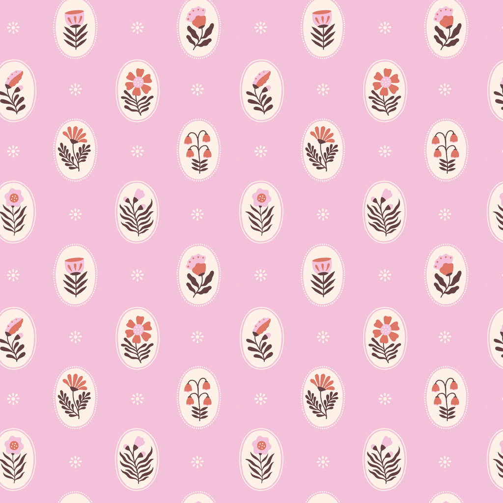 Flat lay of Vera in Bubblegum organic cotton fabric by Cloud9 Fabrics, featuring a dense, whimsical floral pattern of pink and coral wildflowers with dark leafy accents on a warm cream background