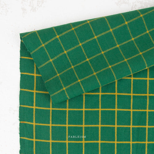 Green fabric with yellow checkered pattern on a white background