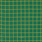 A close-up of green fabric with a yellow grid pattern, showing the woven texture and a small 'FABLEISM' watermark near the bottom center.