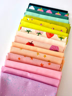 A bright, overhead shot of sixteen overlapping folded fabric pieces. Features a gradient of lavender, bubblegum pink, and peach fabrics with star and strawberry prints, a large-scale strawberry print on cream, transitioning into zesty lime greens, mint, and deep teal fabrics with pink strawberry motifs. The entire collection is displayed against a clean white background.