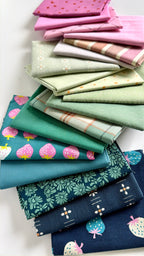 Stack of colorful fabric swatches with various patterns on a white background