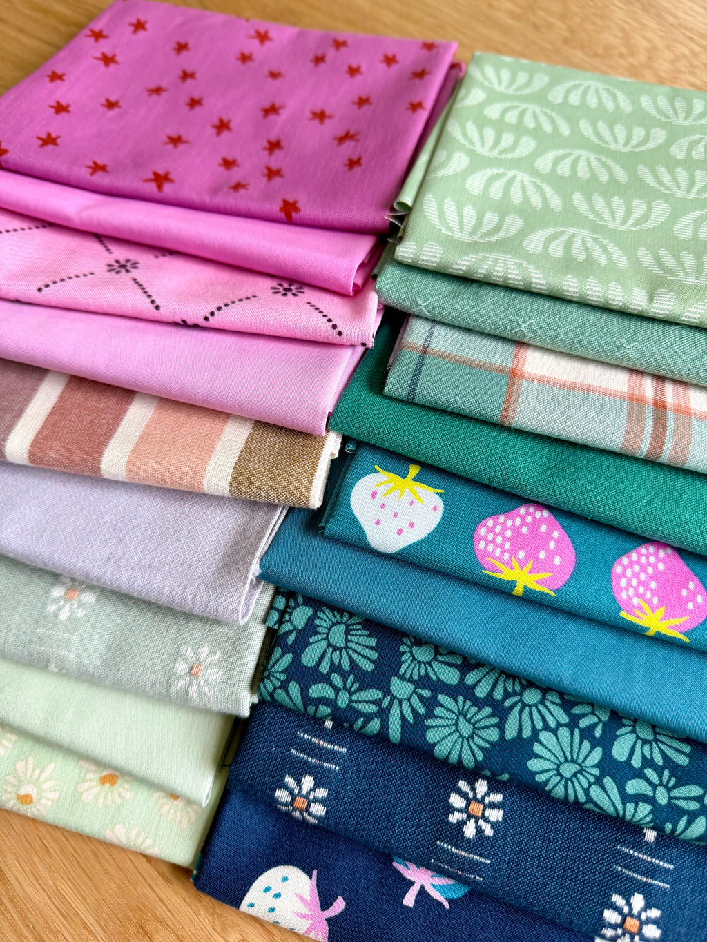 Collection of colorful fabric swatches with various patterns on a wooden surface