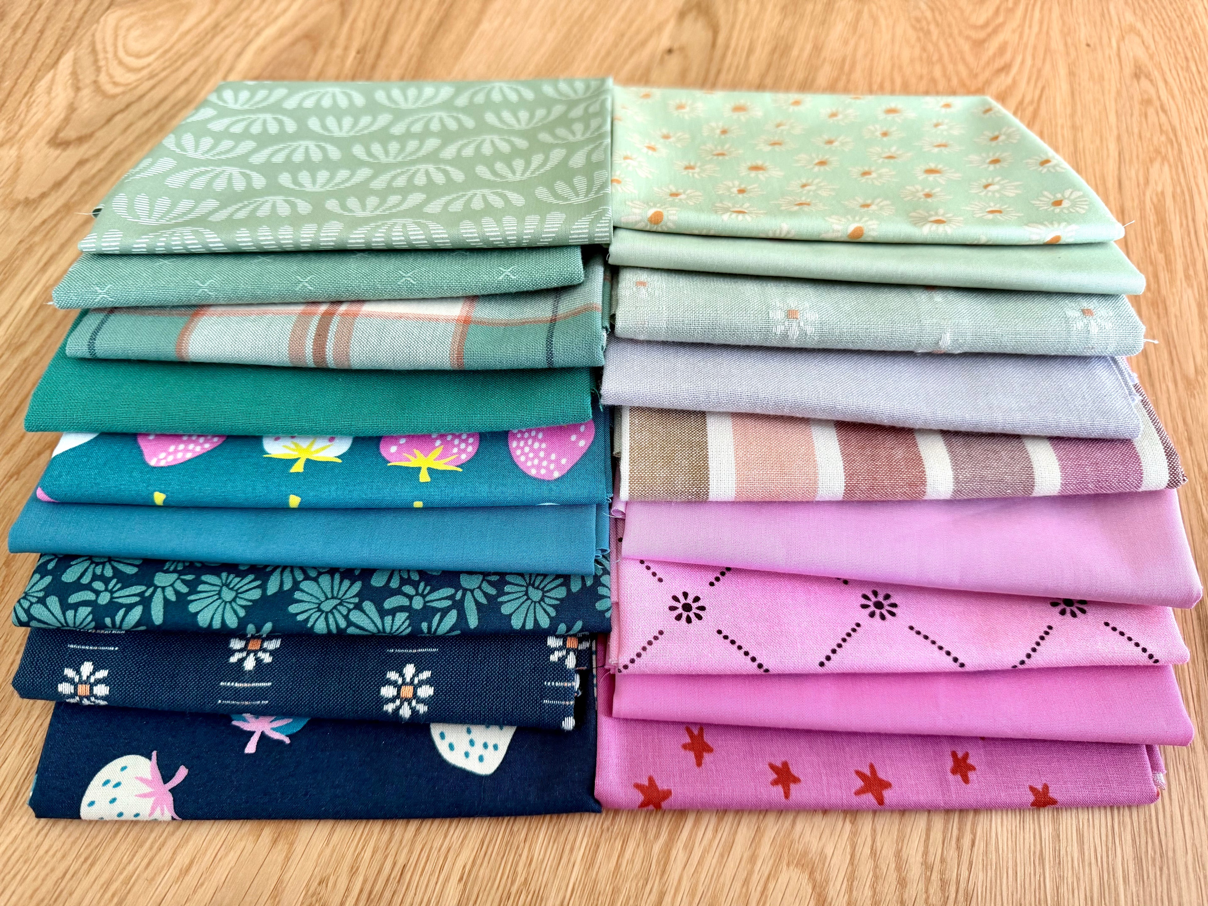 Stack of colorful fabric swatches on a wooden surface