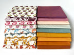 Stack of colorful fabric swatches on a white background