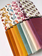 Collection of fabric swatches with various patterns and colors on a white background