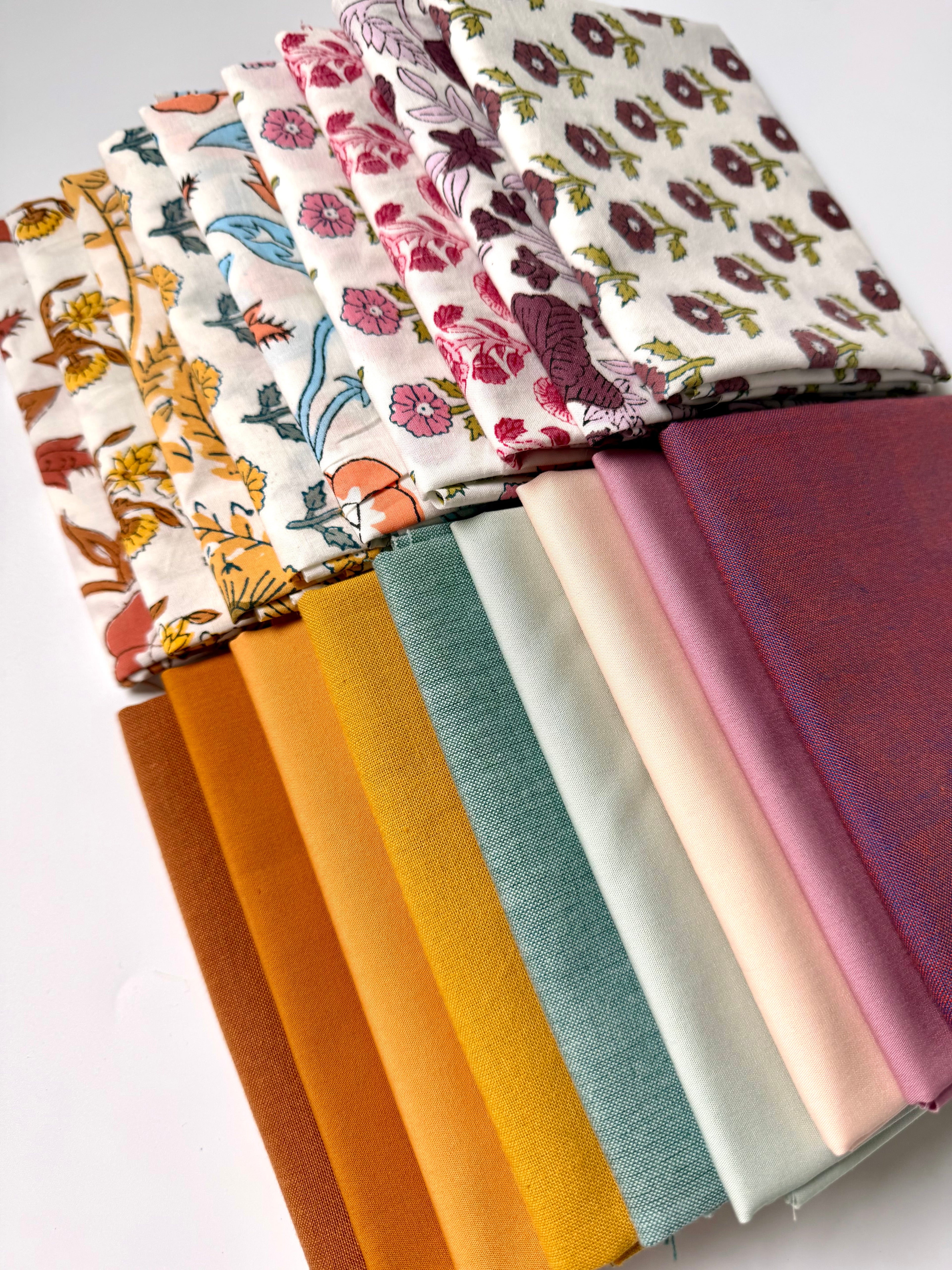 Collection of fabric swatches with various patterns and colors on a white background