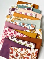 Collection of fabric swatches with various patterns and colors on a white background