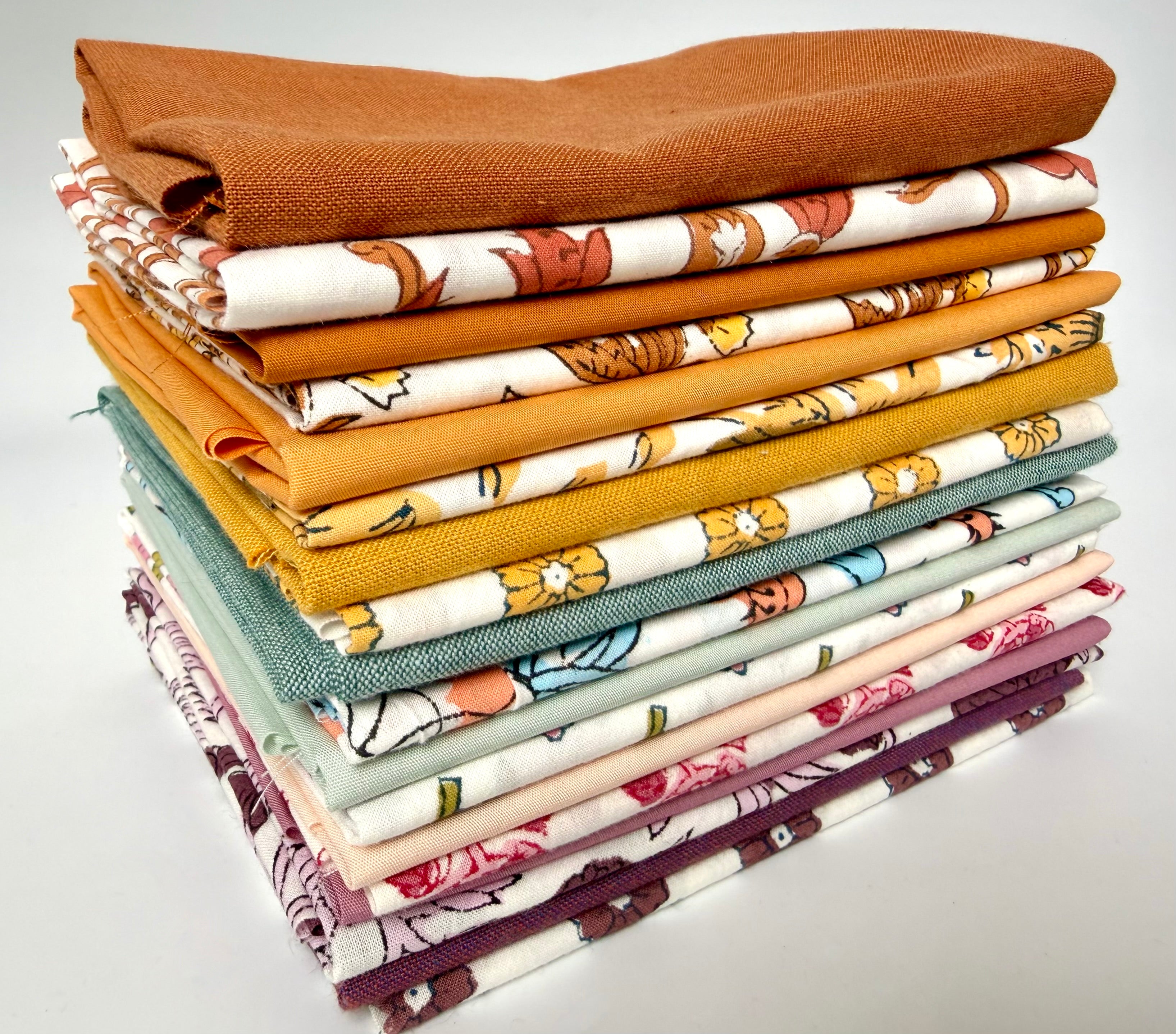 Stack of colorful fabric swatches on a white background