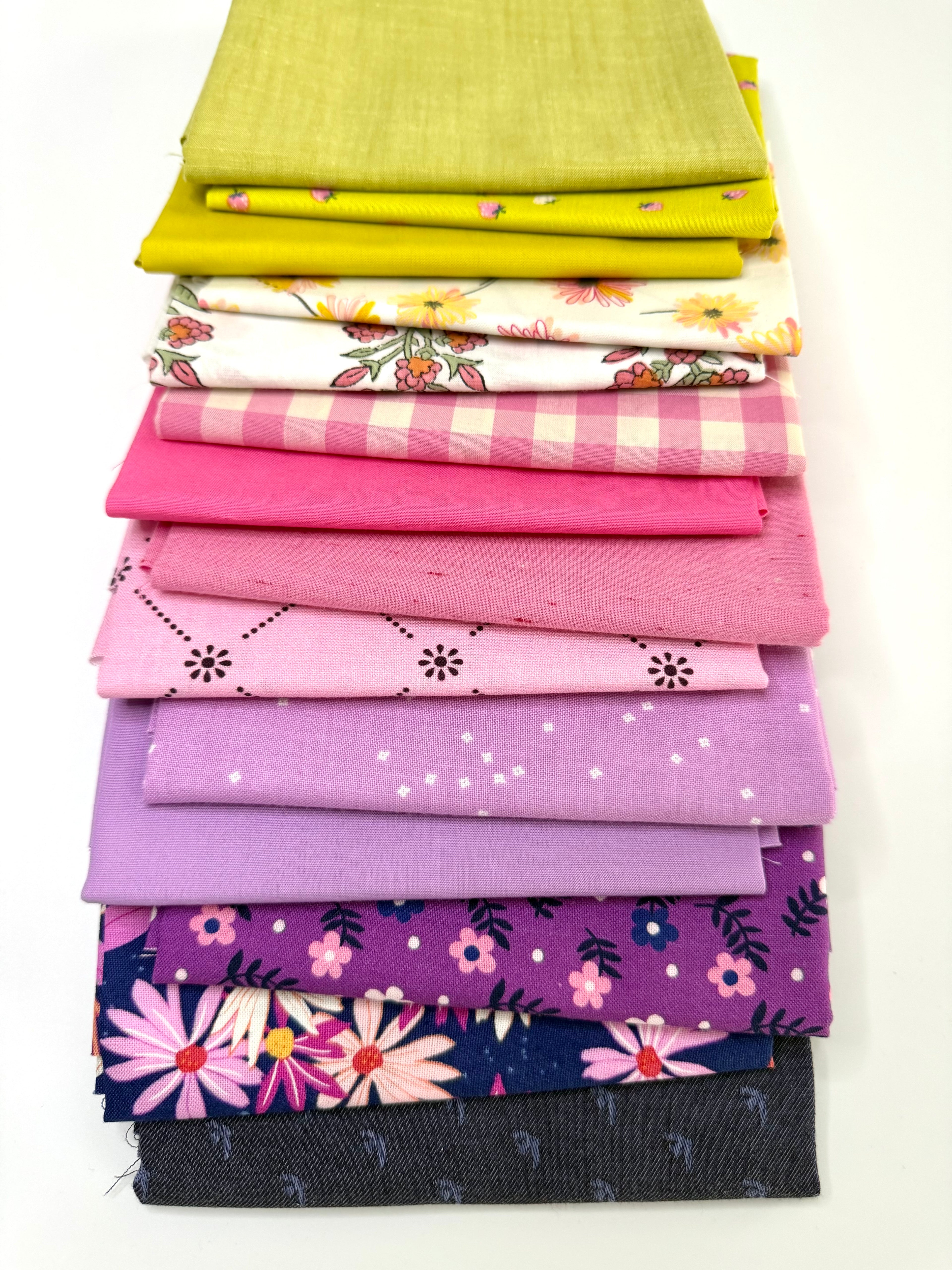 Stack of colorful fabric swatches on a white background
