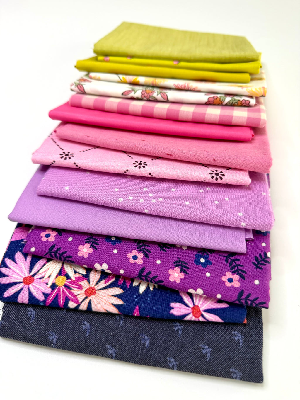 Stack of colorful fabric swatches on a white background