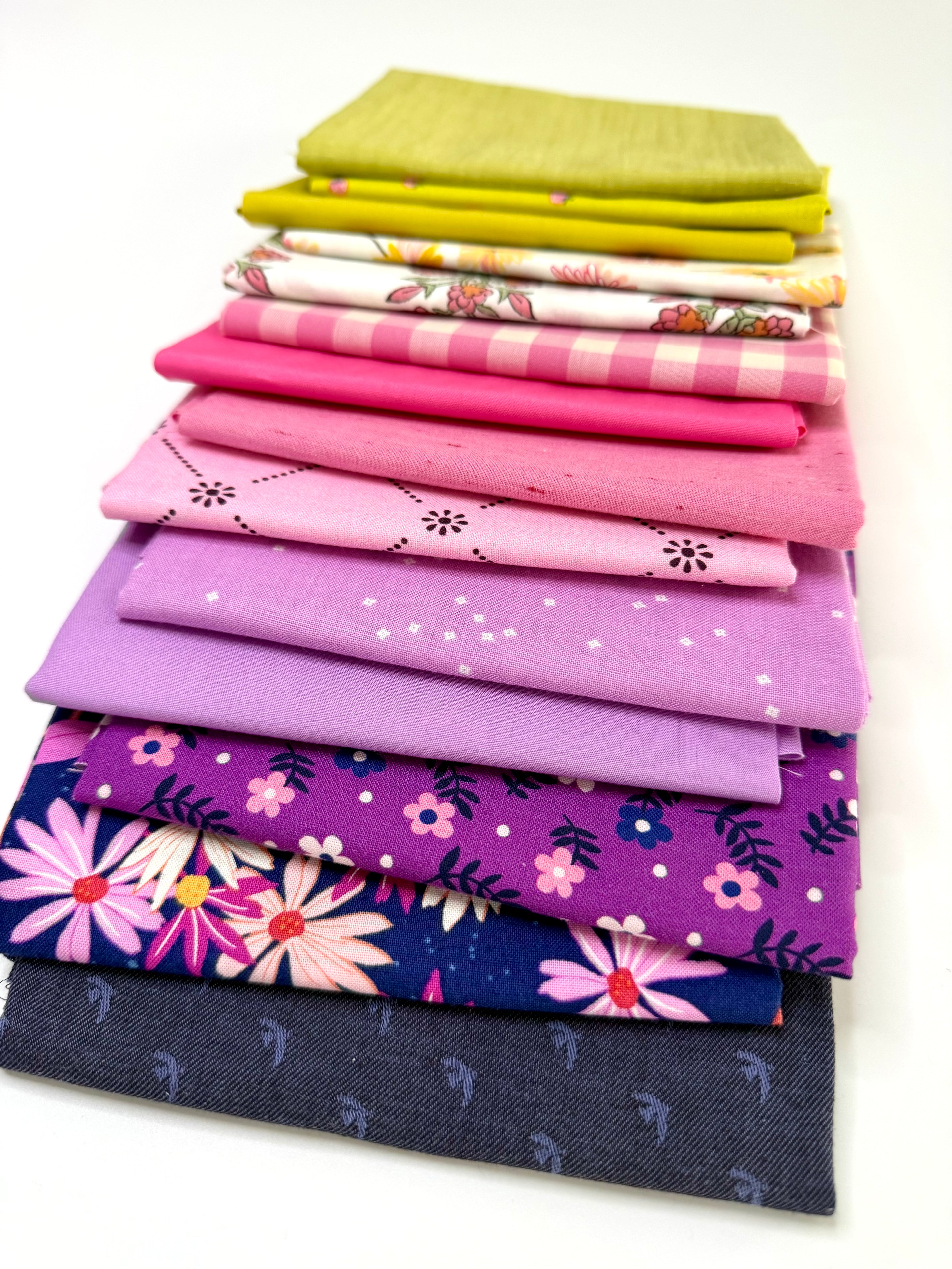 Stack of colorful fabric swatches on a white background