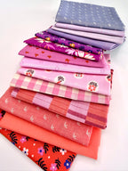 Stack of colorful fabric neatly folded and stacked on a white background