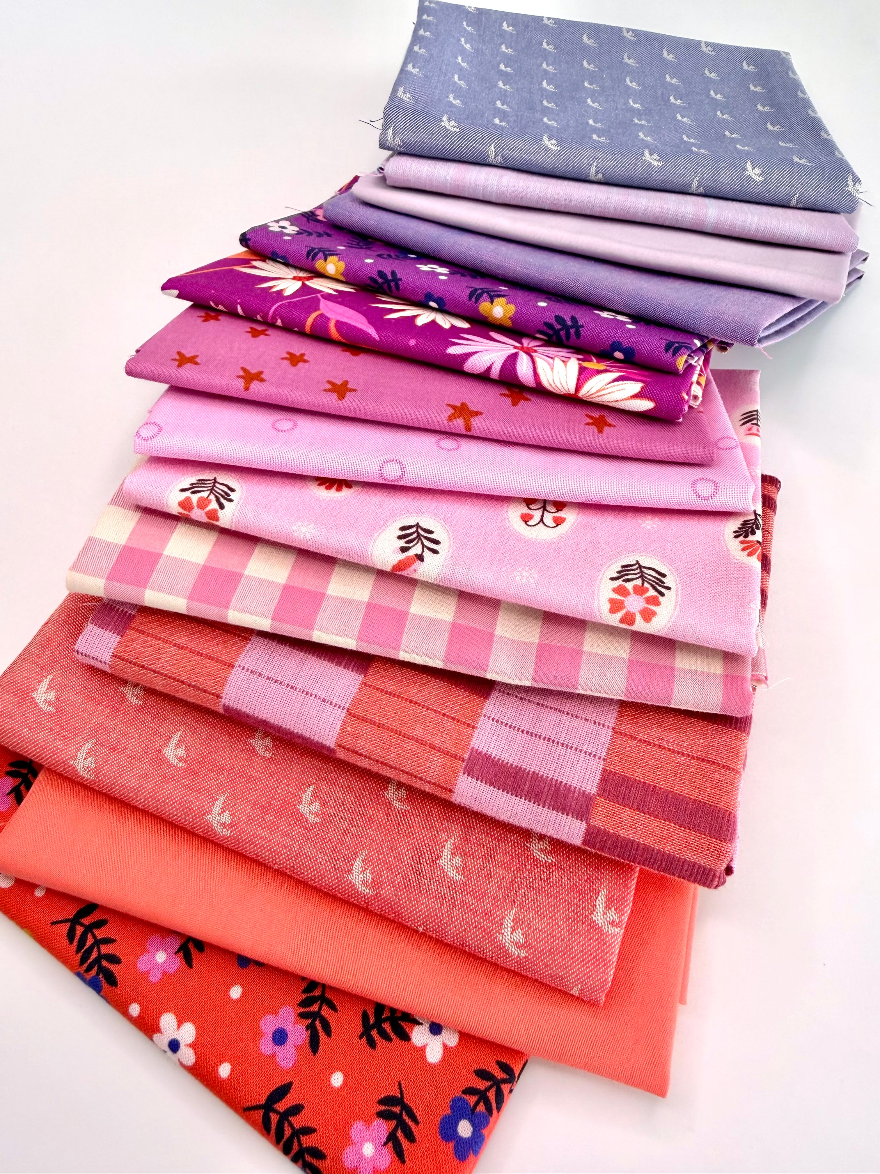 Stack of colorful fabric neatly folded and stacked on a white background
