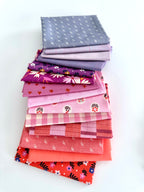 Stack of colorful fabric neatly folded and stacked on a white background