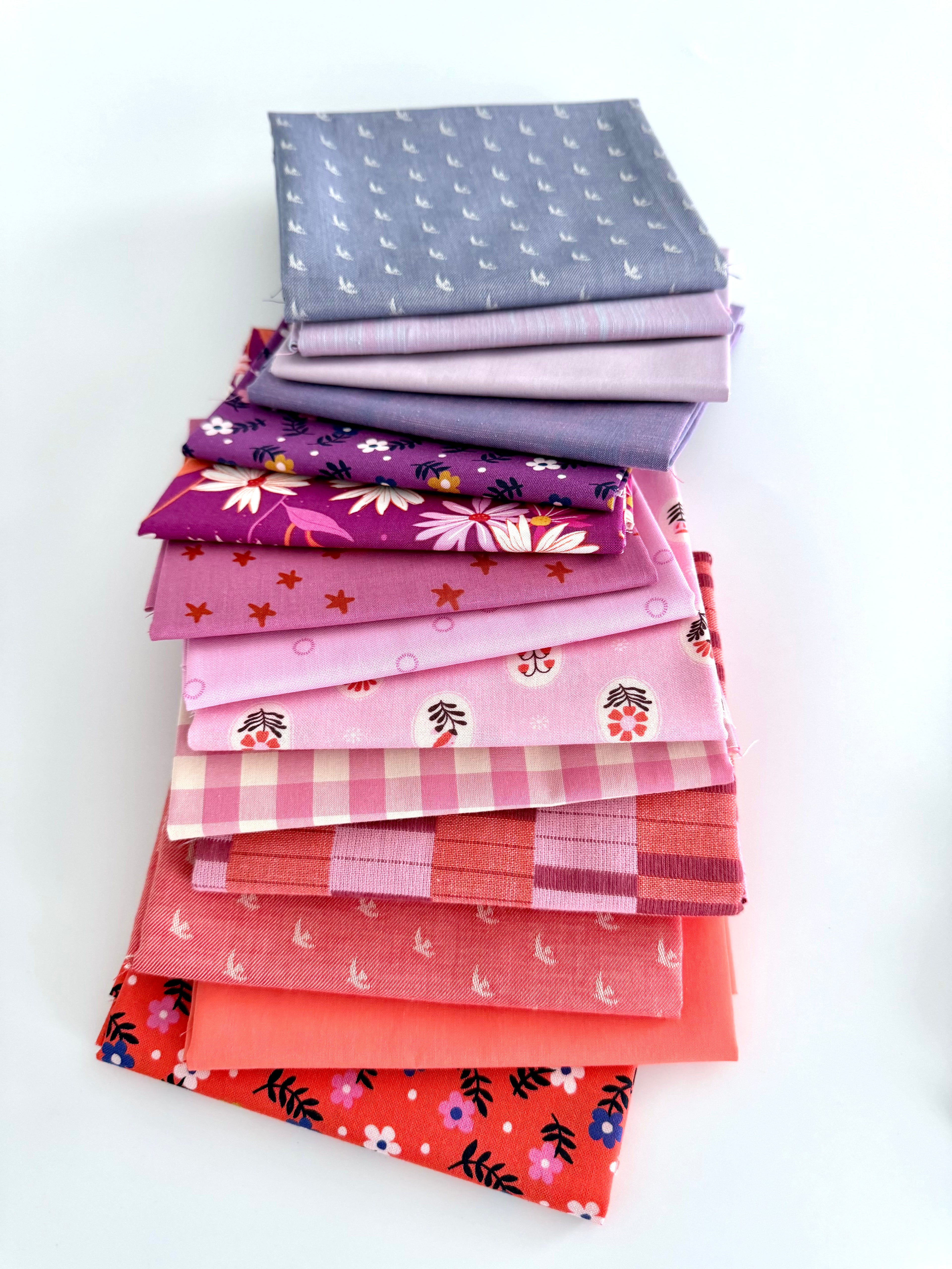 Stack of colorful fabric neatly folded and stacked on a white background
