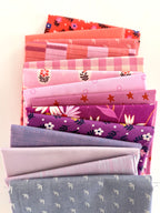 Stack of colorful fabric neatly folded and stacked on a white background