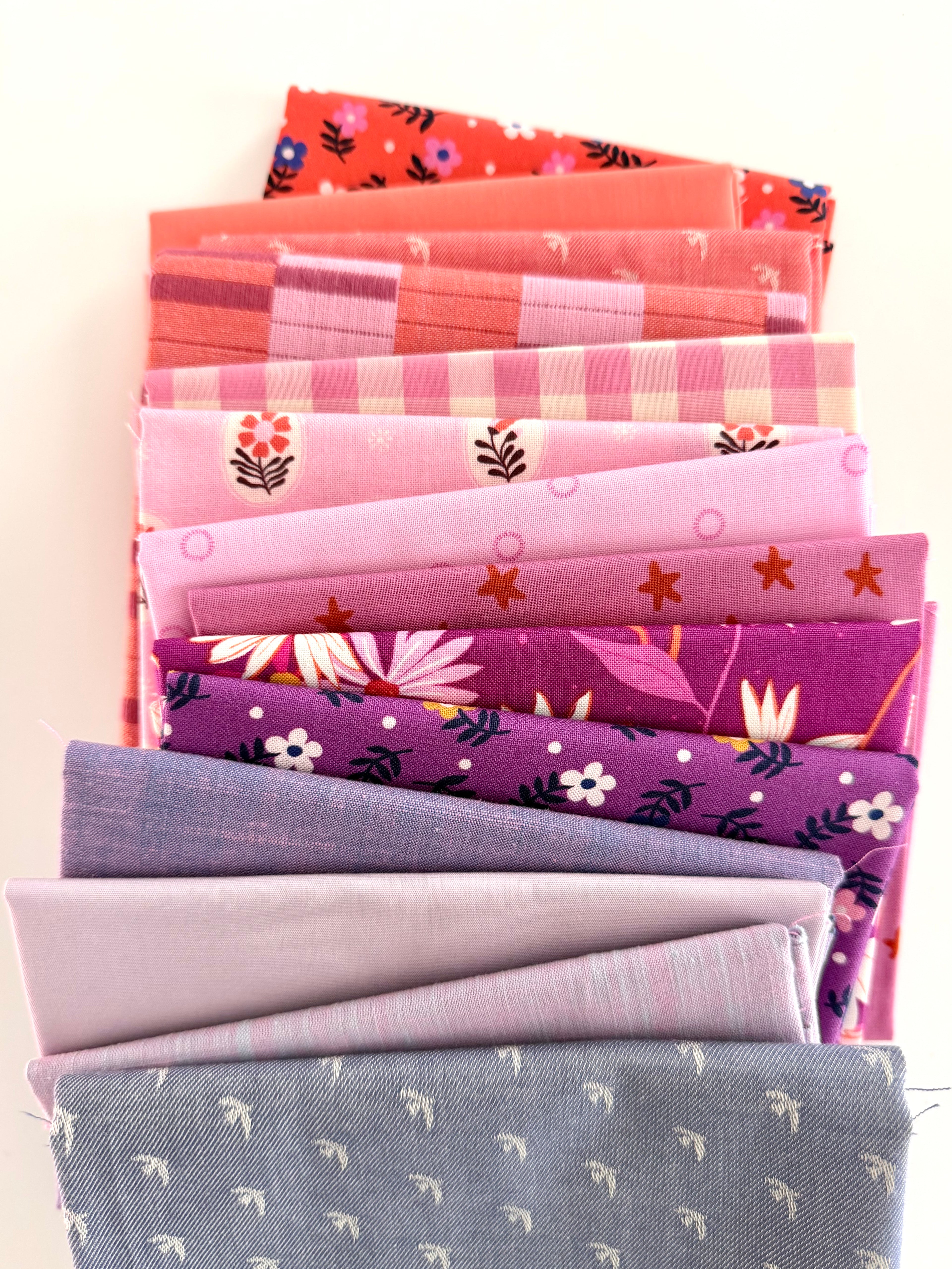 Stack of colorful fabric neatly folded and stacked on a white background